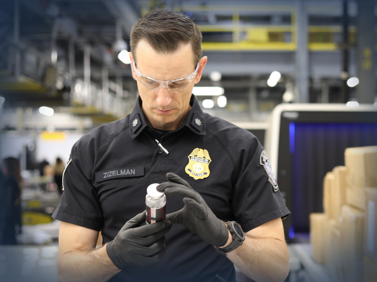 Chief Supervisory CBP Officer Eric Zizelman examines the contents of an express cargo shipment at the Port of Cincinnati