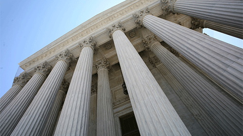 White building with stone columns.