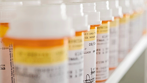 Rows of prescription medicine containers.