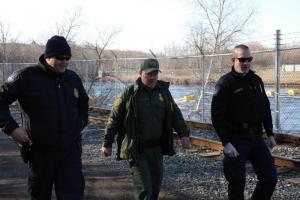 CBP officers in the blue uniforms work with a Border Patrol agent along the U.S.-Canada border. Photo by Sid Lagos