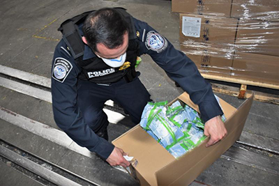 CBP officer inspects a shipment of personal protective equipment