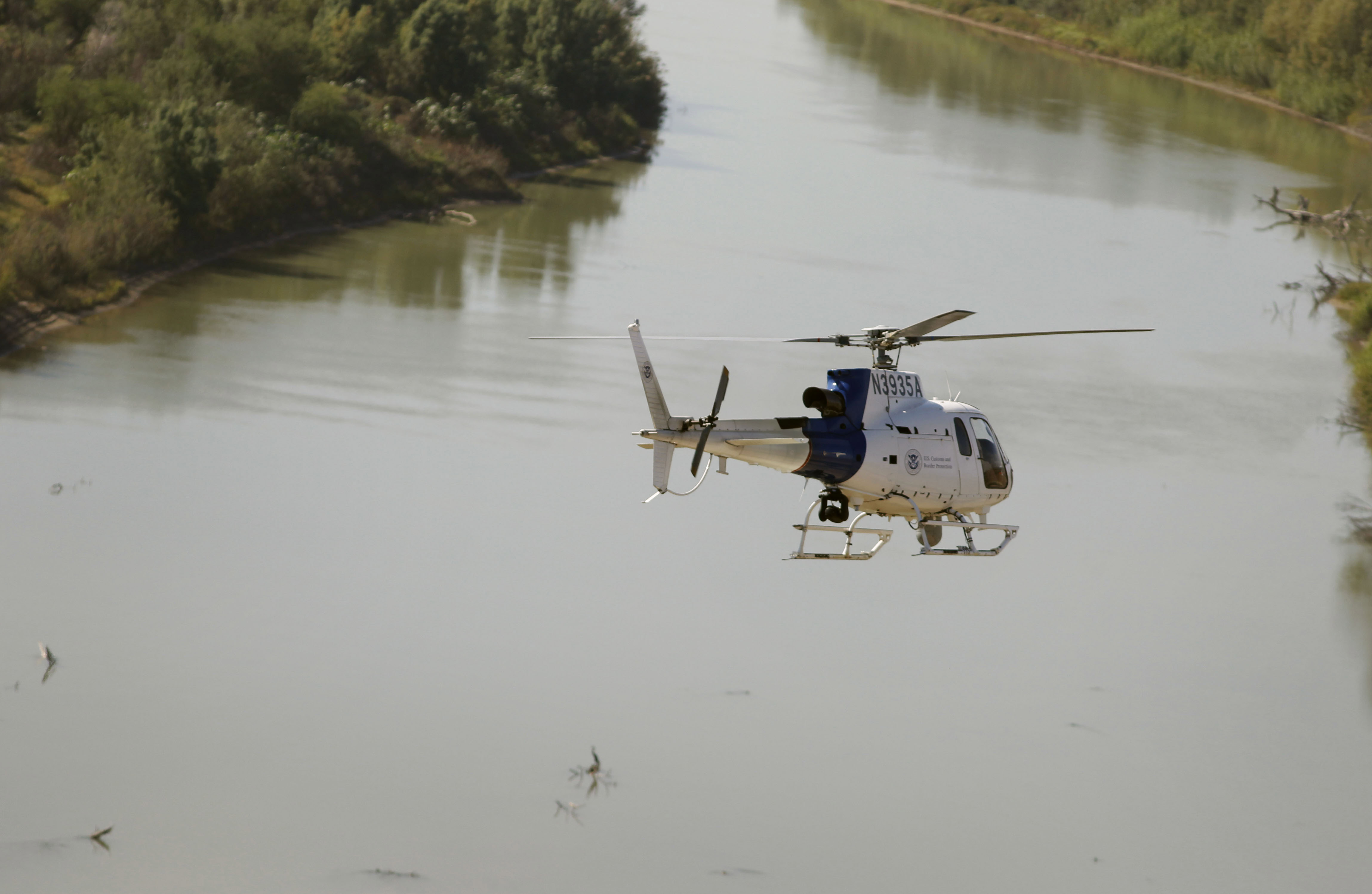 An Air and Marine Operations AS350 crew flies over the Rio Grande River 