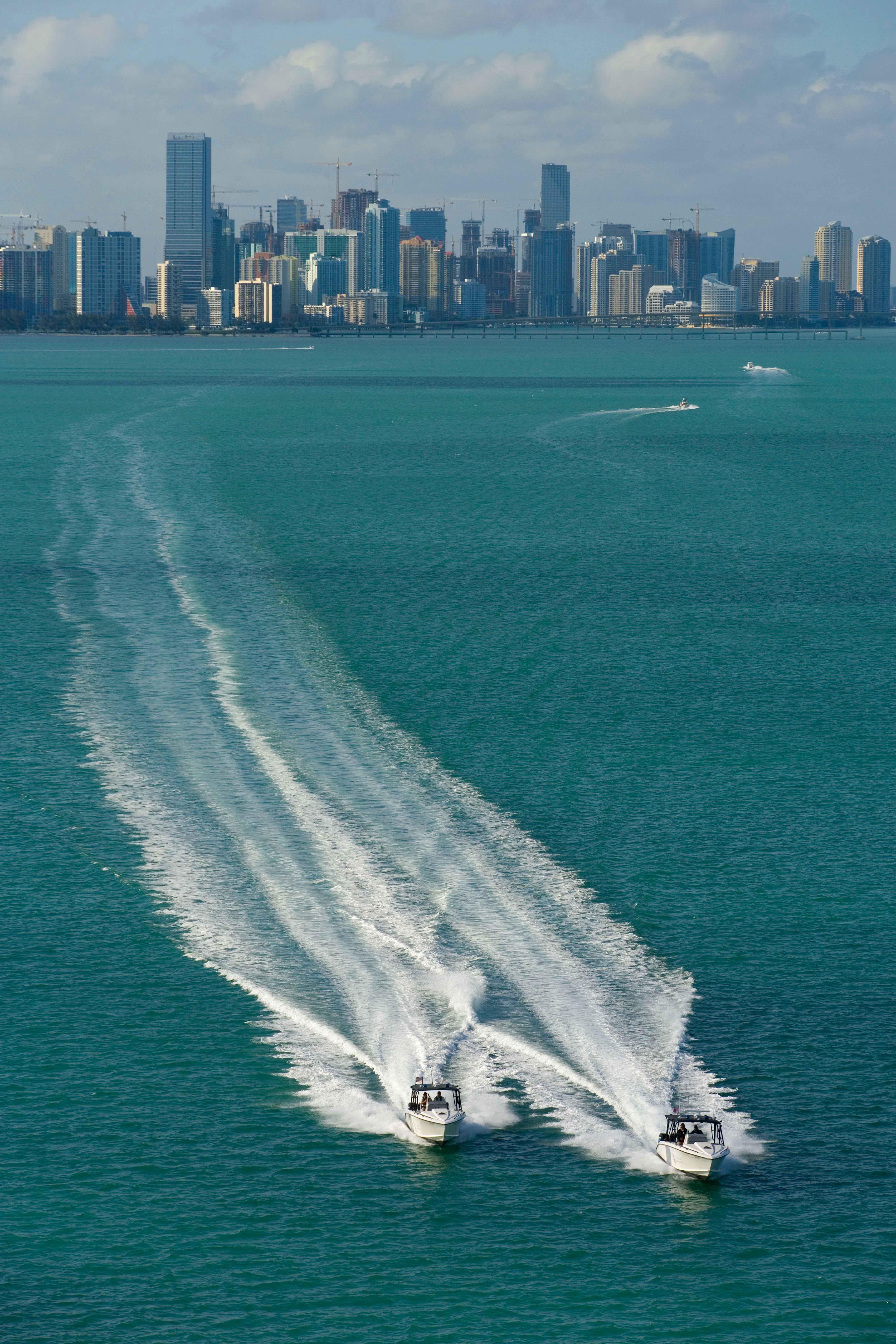 Two CBP Marine unit Midnight Express boats patrol the waters off of Miami, Florida's shores.