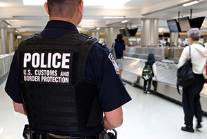 CBP officer on a roving enforcement team keeps watch over travelers at Washington Dulles International Airport.