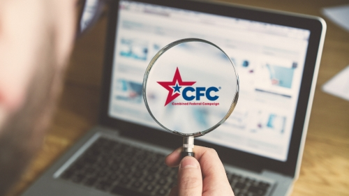 Looking at a computer screen with a magnifying glass, CFC logo displaying in magnifying glass