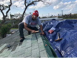 Roche works on a roof in the Bahamas.