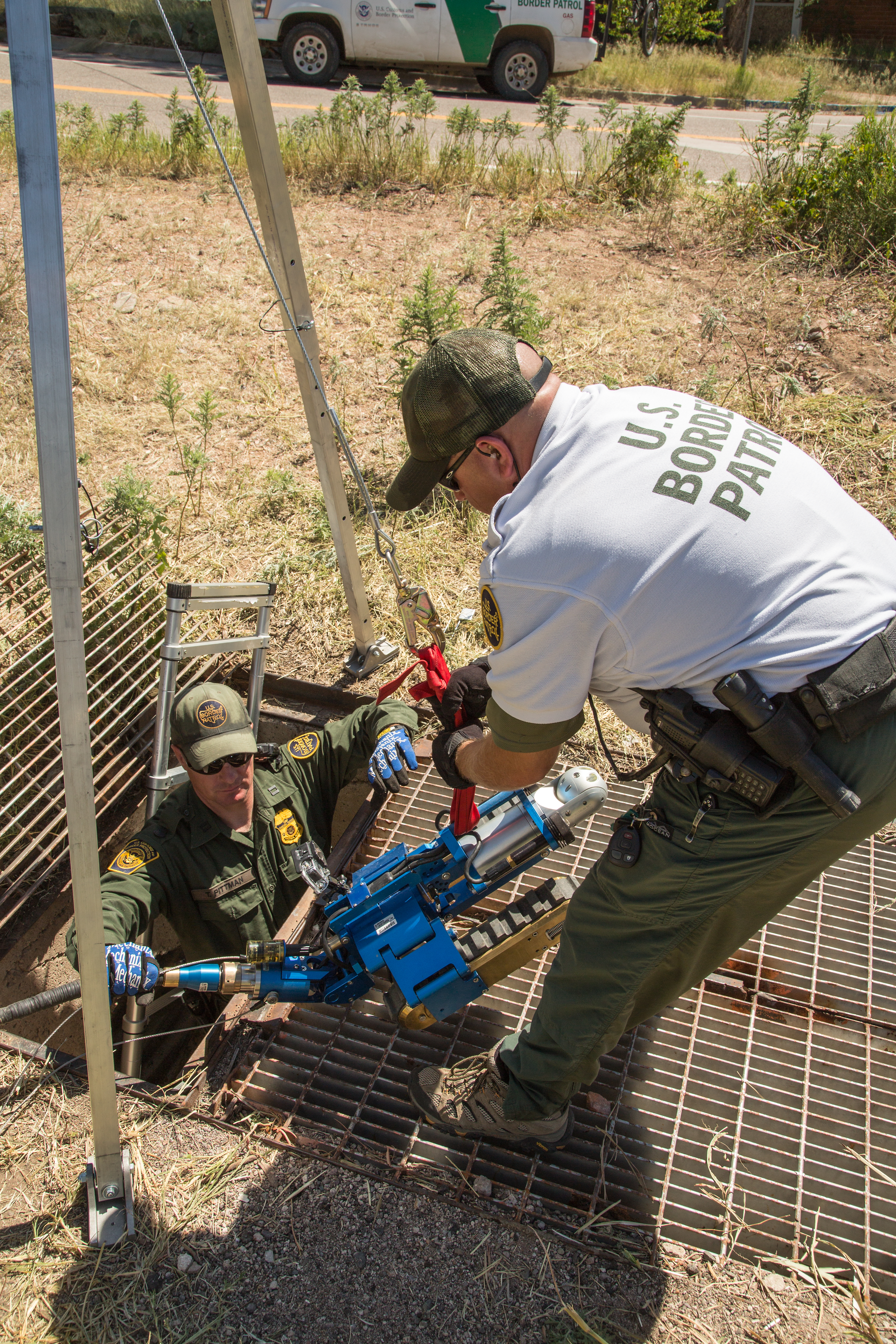 Border Patrol agents pull the robot back to the surface after its search mission is complete.
