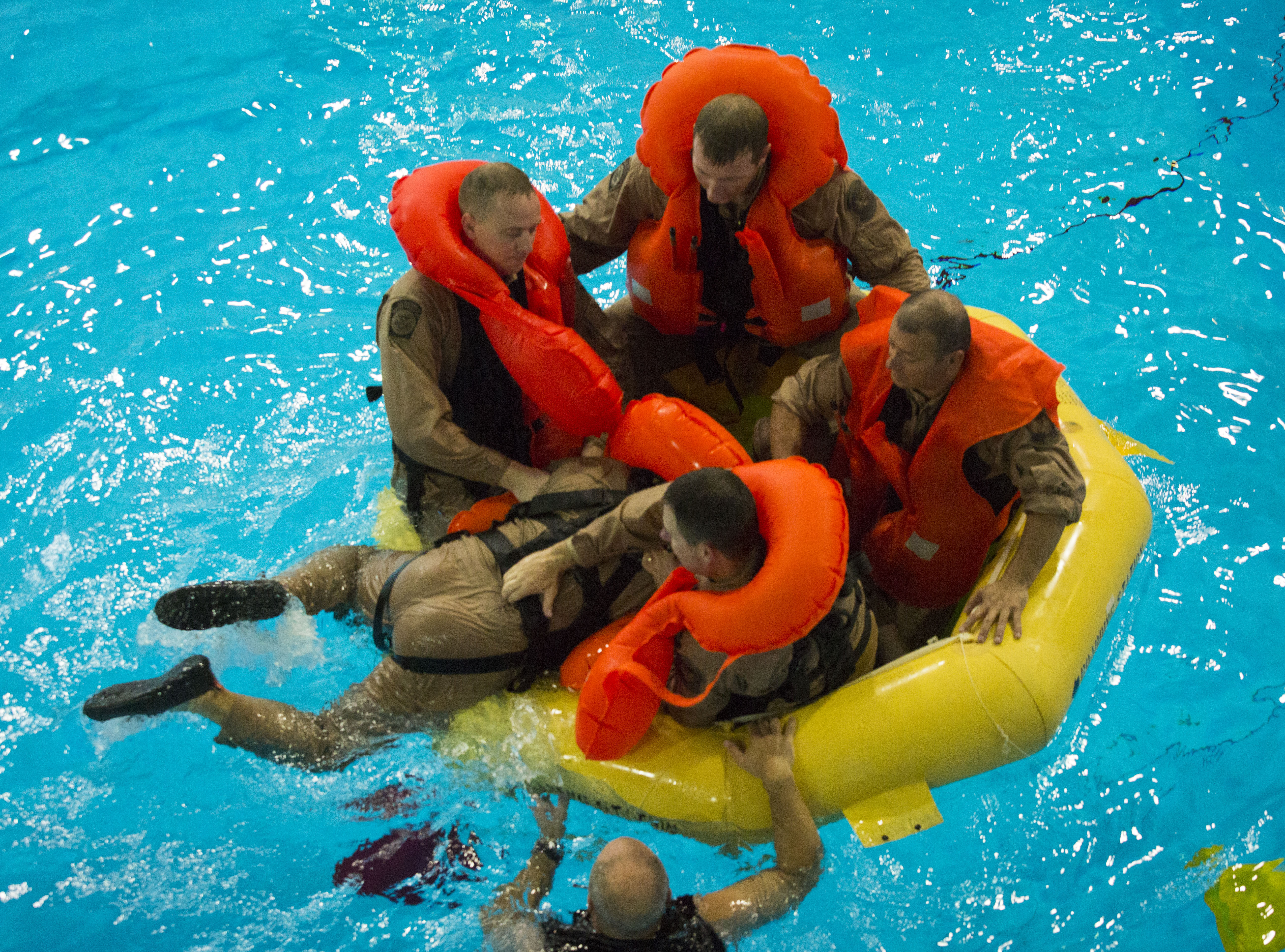 Water survival training gives agents an opportunity to practice boarding a raft.