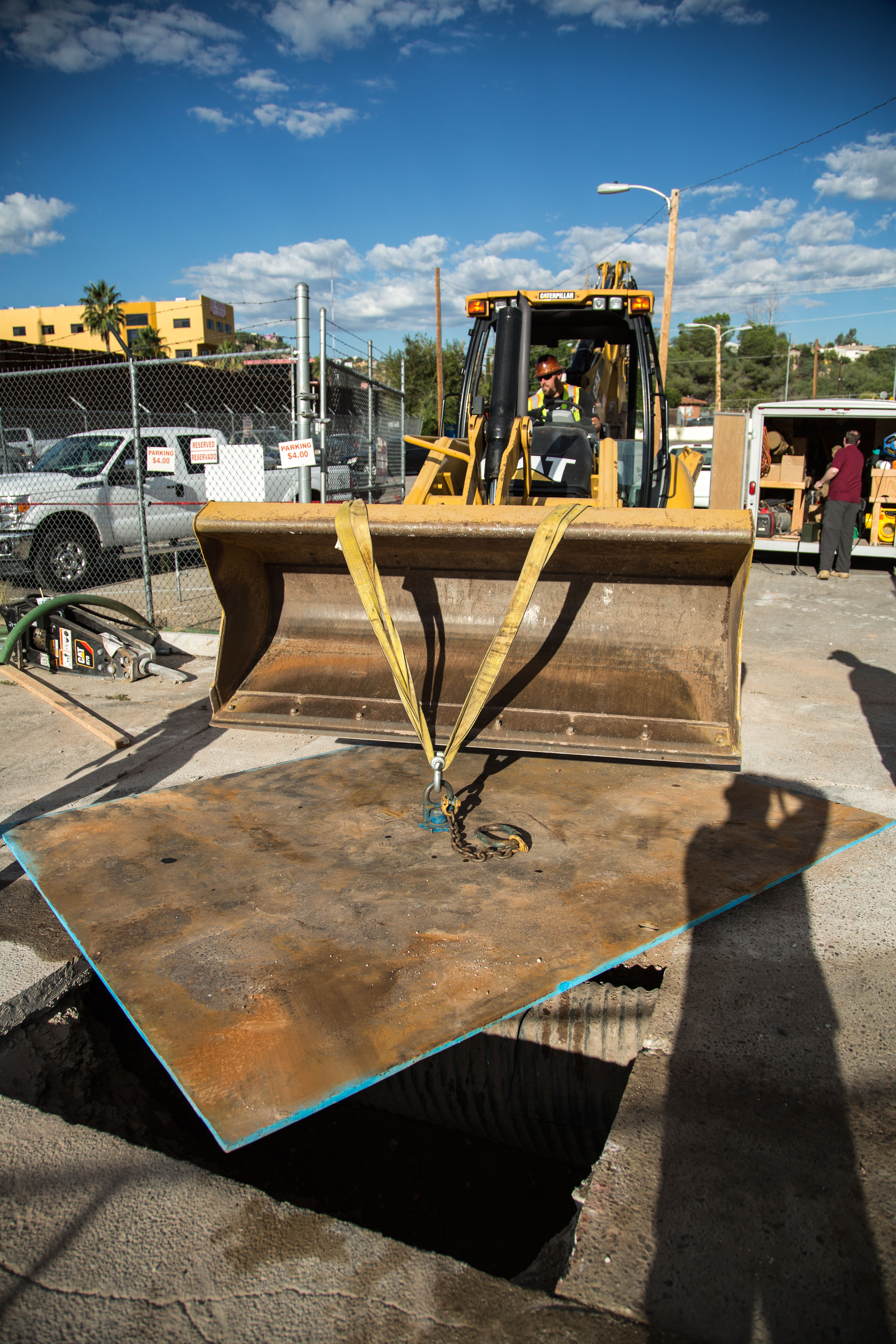 A bulldozer is used to open an area where a tunnel was discovered in a Nogales parking lot