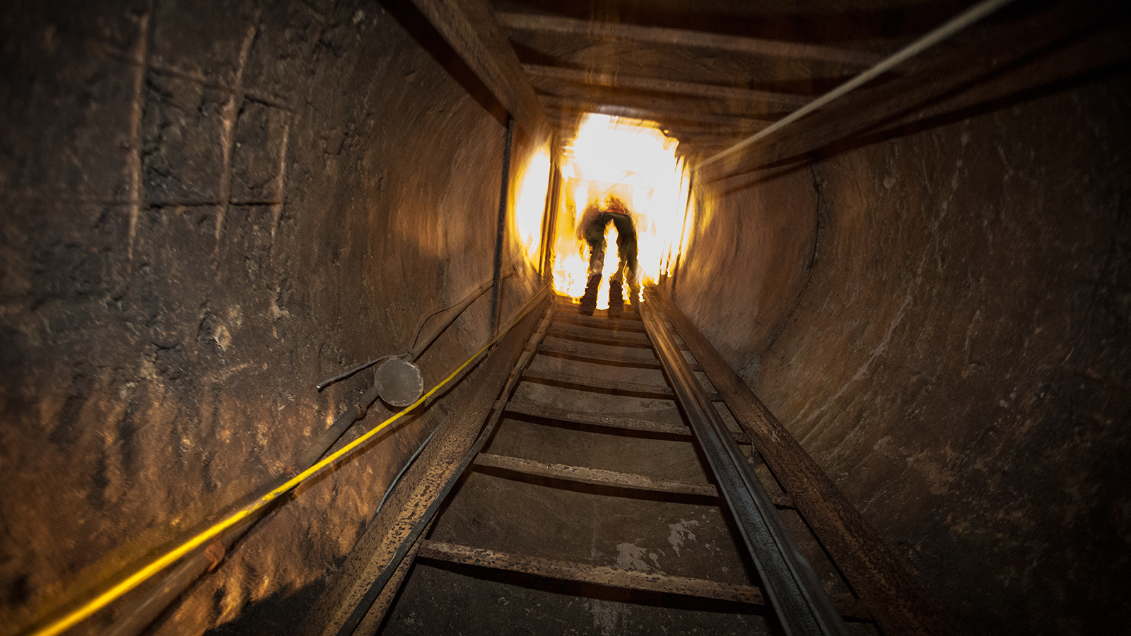 A photo showing Border Patrol agents exploring the tunnel