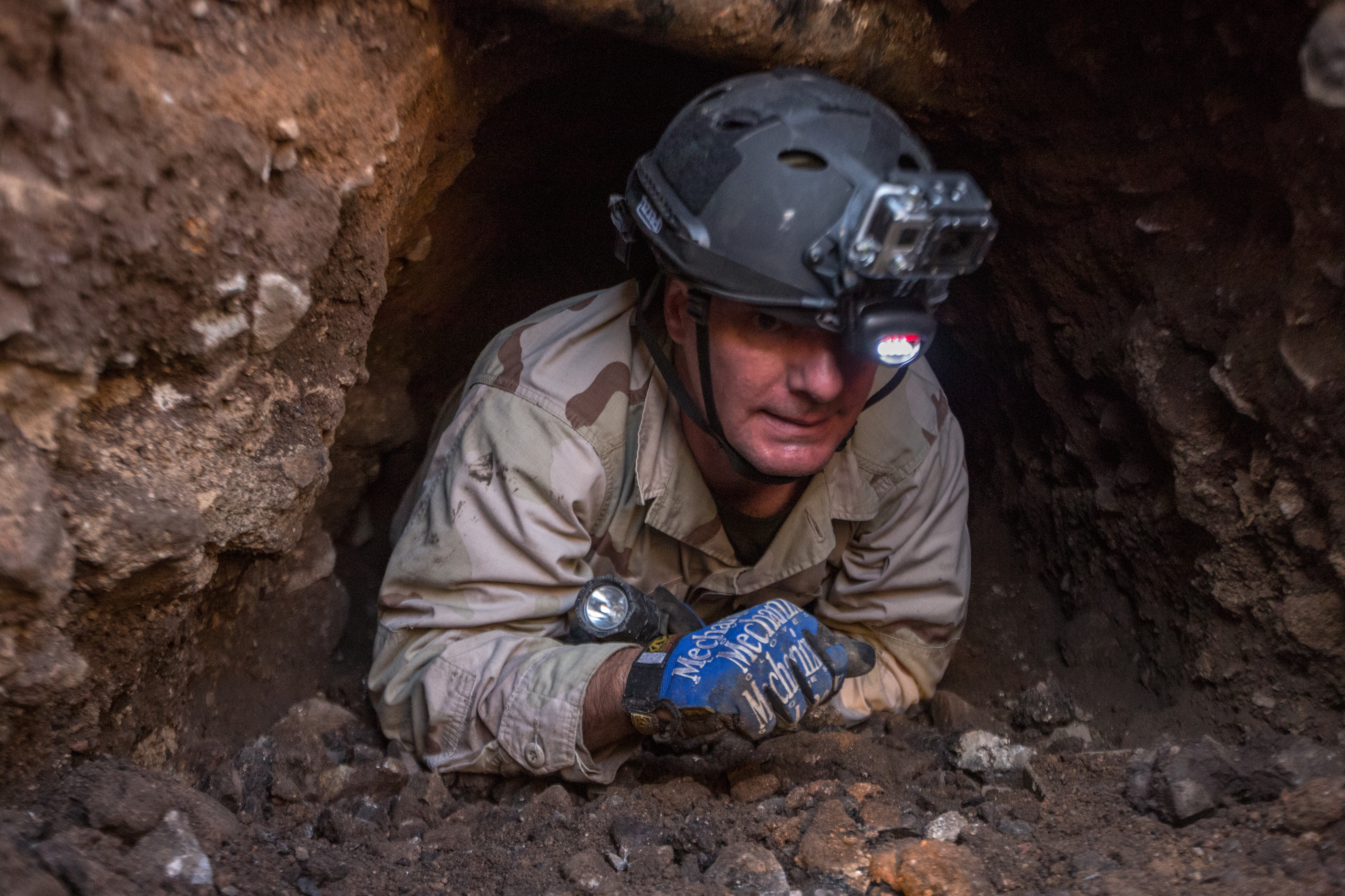 Supervisory Border Patrol Agent Thomas Pittman emerges from the hand dug tunnel section