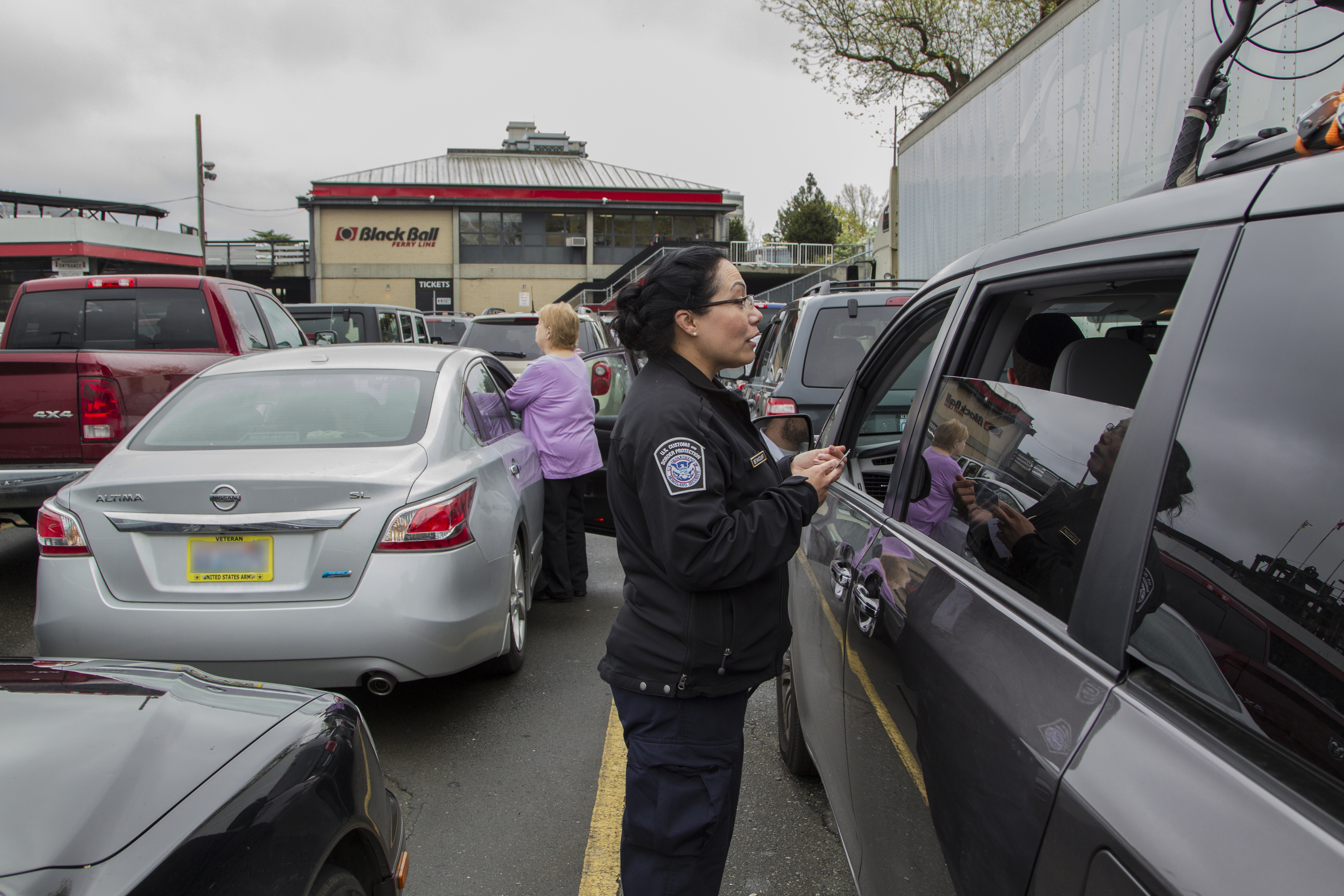 A CBP officer initiates pre-inspection processing by speaking with drivers queued to board one of the ferries between Victoria, British Columbia, and the U.S.