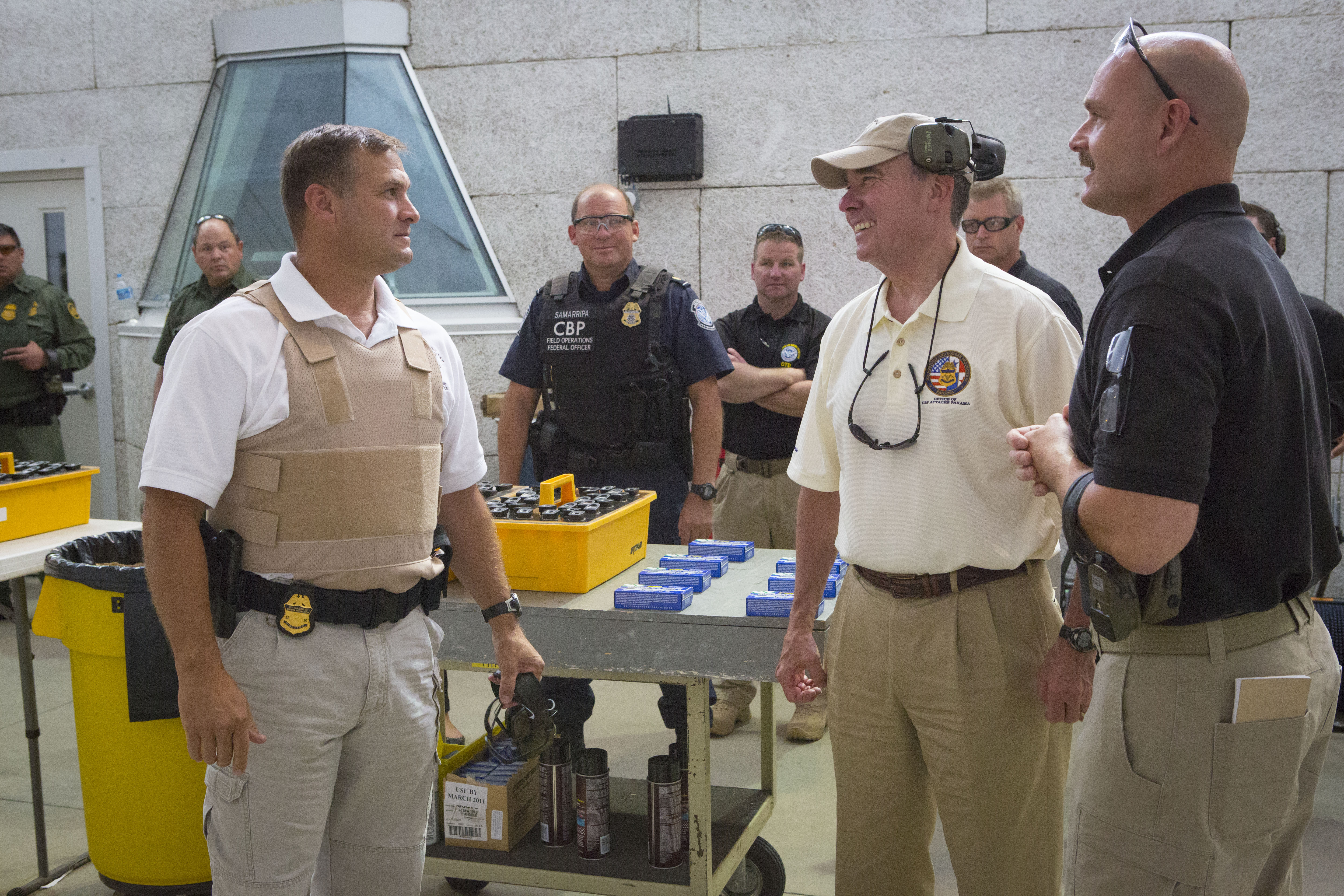 Commissioner Kerlikowske and CBP Advanced Training Center Assistant Director Dave Corolis, right, speak with Firearms Instructor Training Program participants at the center’s firing ranges in August.