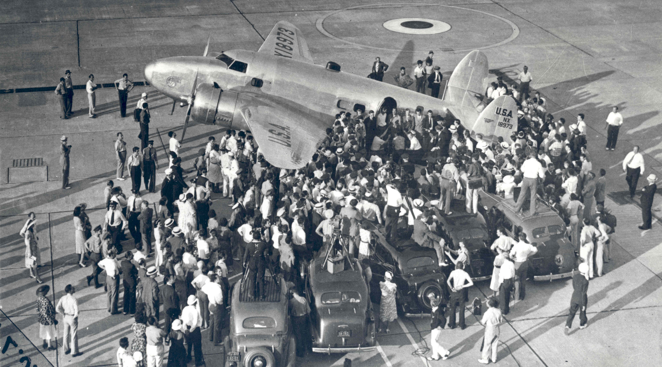 Floyd Bennett Field on Long Island, New York, was a site where one record after another was set and broken in rapid succession during the golden era of aviation between the two world wars. In this photograph, Hughes and his crew prepare to set out for Paris from the Field on the first leg of their tour. Their 91-hour adventure generated publicity for the World's Fair, set to open the following year -- and made Howard Hughes an international celebrity.
