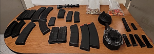 Displayed on a table are magazines, rounds of ammunition of various calibers and related parts seized by CBP officers at Eagle Pass Port of Entry.