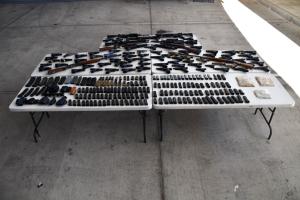 Laid out on tables are 83 weapons, 680 rounds of ammunition, 172 magazines, four scopes, seven holsters and one laser seized by CBP officers at Del Rio Port of Entry during an outbound examination.