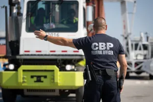 CBP officer directing a truck through an NII inspection