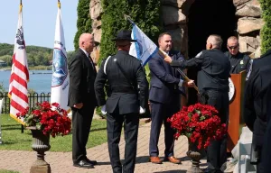 Don Stakes, Acting Director of Field Operations, Buffalo, New York presented the guidon to Raymond Purser, Area Port Director of Alexandria Bay, New York during a change of command ceremony.