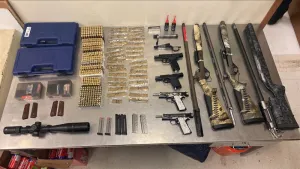 A table display of four handguns, six magazines, 21 weapons components and 1,070 rounds of ammunition seized by CBP officers during an outbound examination at Hidalgo Port of Entry.