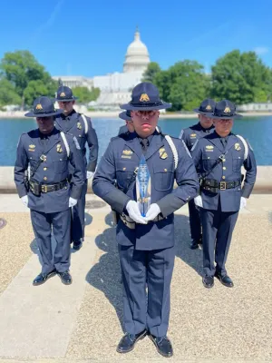 Members of the Laredo Port of Entry Honor Guard Drill Team pose in formation  in front of the nation's capital with the Chief Judge Award they earned at the Steve Young National Honor Guard competition held in Washington, DC during National Police Week.