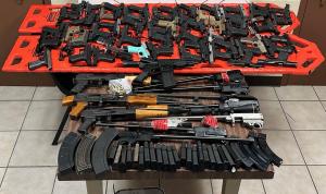 Spread over a table are 67 weapons, 69 magazines and 33 rounds of ammunition seized by CBP officers at Progreso International Bridge.