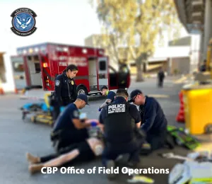 CBP officers preparing the woman for transportation to a local hospital by San Luis Fire Department.