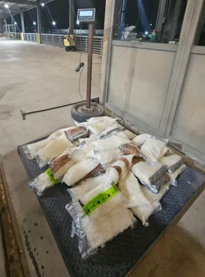 Packages on a scale containing 141 pounds of methamphetamine seized by CBP officers at Eagle Pass Port of Entry.