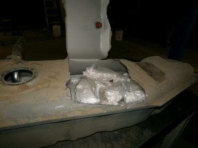 CBP officers more closely inspect the gas tank of the truck and discover dozens more packages of methamphetamine.