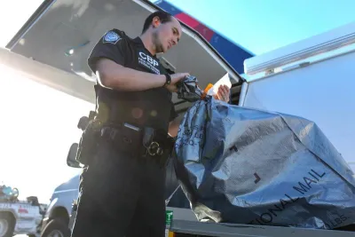 CBP Officer inspects international mail.