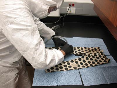 Andrew Laurence a CBP palynologist – a pollen scientist – uses a forensic vacuum to take a pollen sample from a pair of pants.
