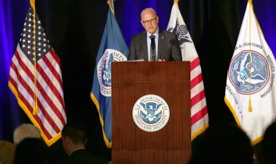 CBP Commissioner Chris Magnus stands at a podium and welcomes attendees to the CBP 2022 Trade Facilitation and Cargo Security Summit.