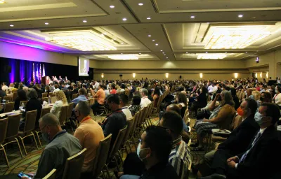 Photos of attendees facing the stage in a crowded room at the Trade Summit.