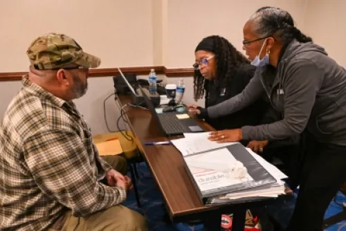 Photograph of VBA personnel assisting a CBP Veteran with his disability claims at the Disabilities Claim Clinic November 12, 2024, in Annapolis, Maryland.