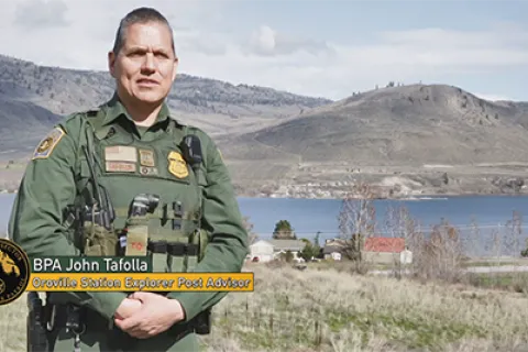 Border Patrol Agent Tafolla standing in front of mountain range