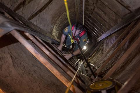 A photo showing Border Patrol agents exploring the tunnel