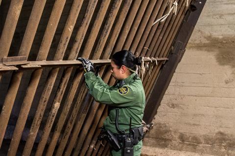 Photo of a Border Patrol agent checking the steel gates in Nogales' main drainage system