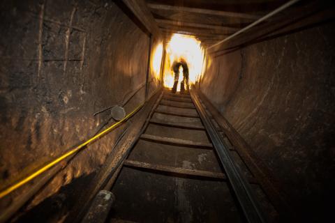 A Border Patrol agent fades into the light as he exits the Douglas Tunnel