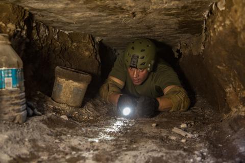 Supervisory Border Patrol Agent Kevin Hecht crawls a hand-dug tunnel in Nogales, Arizona