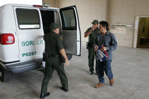 Border Patrol agents transport a prisoner who will be returned to Mexico.