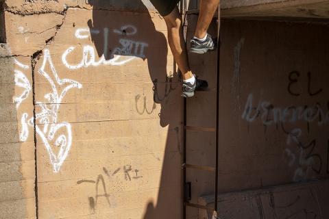 Photo of a Border Patrol agent entering the main drainage tunnel in Nogales, Arizona
