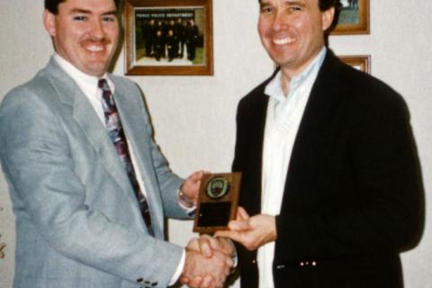 Photo of R. Gil Kerlikowske presenting an award in 1993
