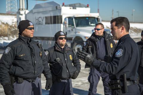 CBP officers deploy high-tech scanning equipment outside stadium to screen all trucks.