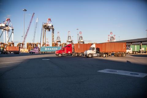 Trucks carry cargo containers away from the Newark, N.J. port of entry after clearing CBP processing.