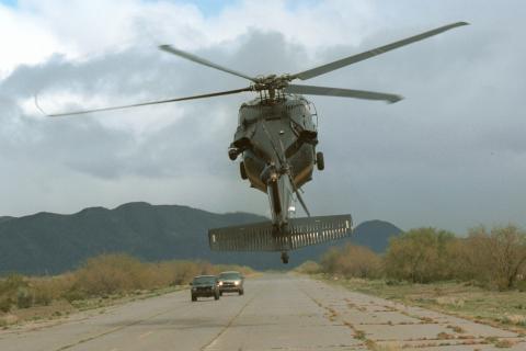 A CBP Air unit UH-60 Black Hawk helicopter intimidates two vehicles.