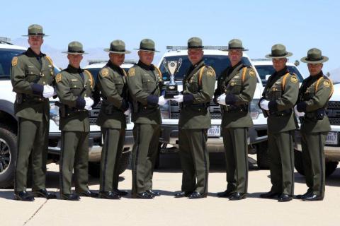 Members Tucson Sector Border Patrol Honor Guard Drill Team pose with the Trophy they recieved for winning the competition