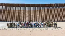 USBP Agents, local media and partners stand in front of border wall in El Centro Sector