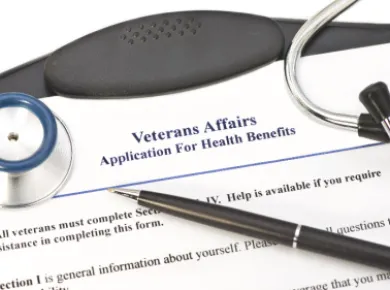 Pen on Veteran Affairs Application for Health Benefits Form