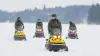 Photo of agents on snowmobiles on the St. Lawrence River.