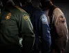 CBP law enforcement officers in silouette.