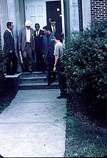 James Meredith is escorted by Federal officials to register for classes at the University of Mississippi. Copyright Estate of Donald James Proehl.
